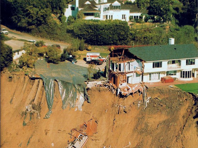 House collapsing over eroded cliff